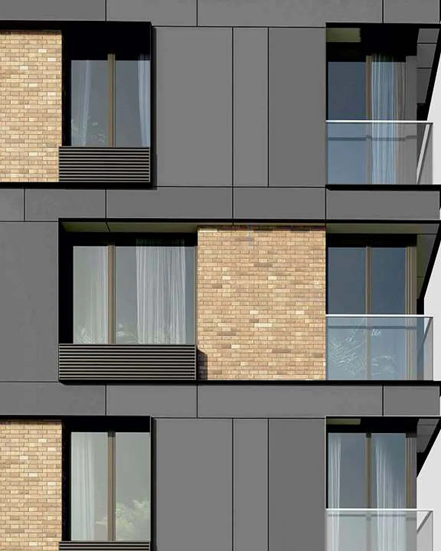 Dark grey aluminum composite panel cladding on a residential facade with brick infill and glass balconies