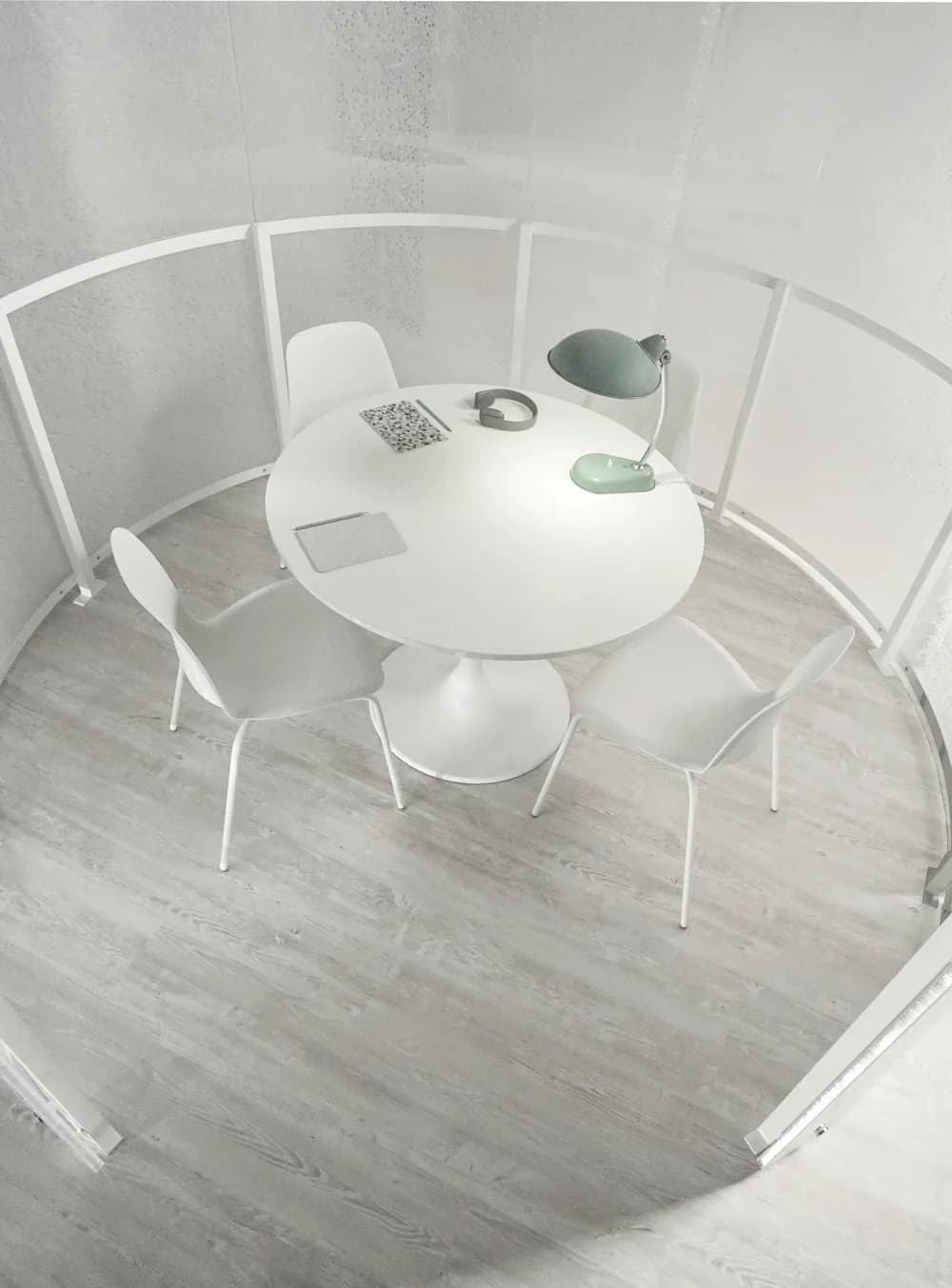 Inside a BePod pod: a round table with a lamp and headphones, the curved panel walls glowing