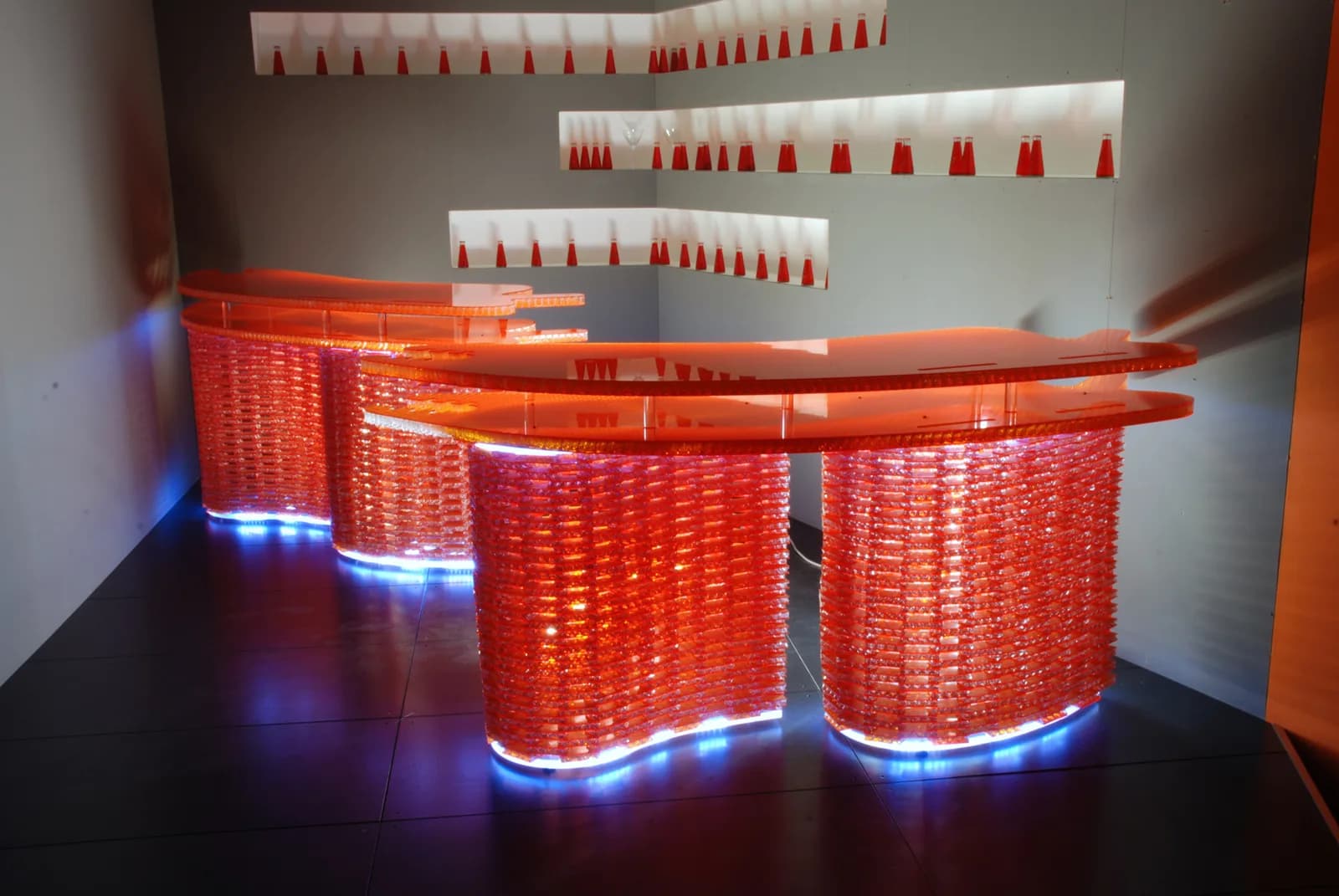 Curved orange Bencore bar counter lit from below