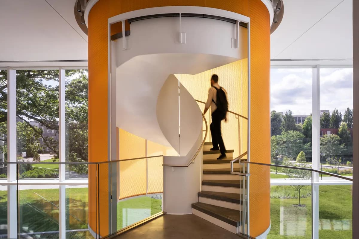 Orange translucent Bencore panels wrapping a spiral stair at the Fascitelli Center