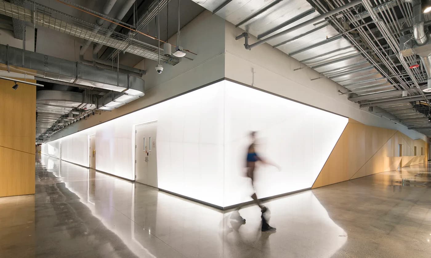 Long backlit white Bencore wall wrapping a corridor at Magic Leap's Miami headquarters