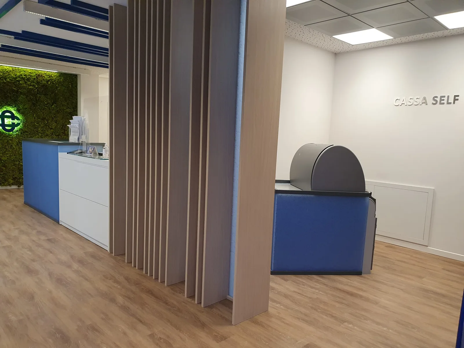 Dark hexagonal patterned panels behind a lit reception desk