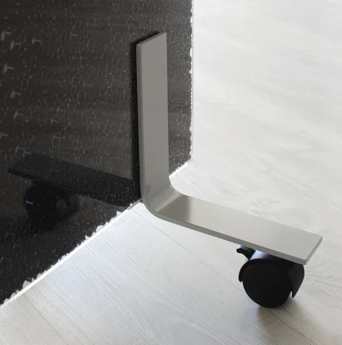 Upset Wheels castor foot on a dark panel