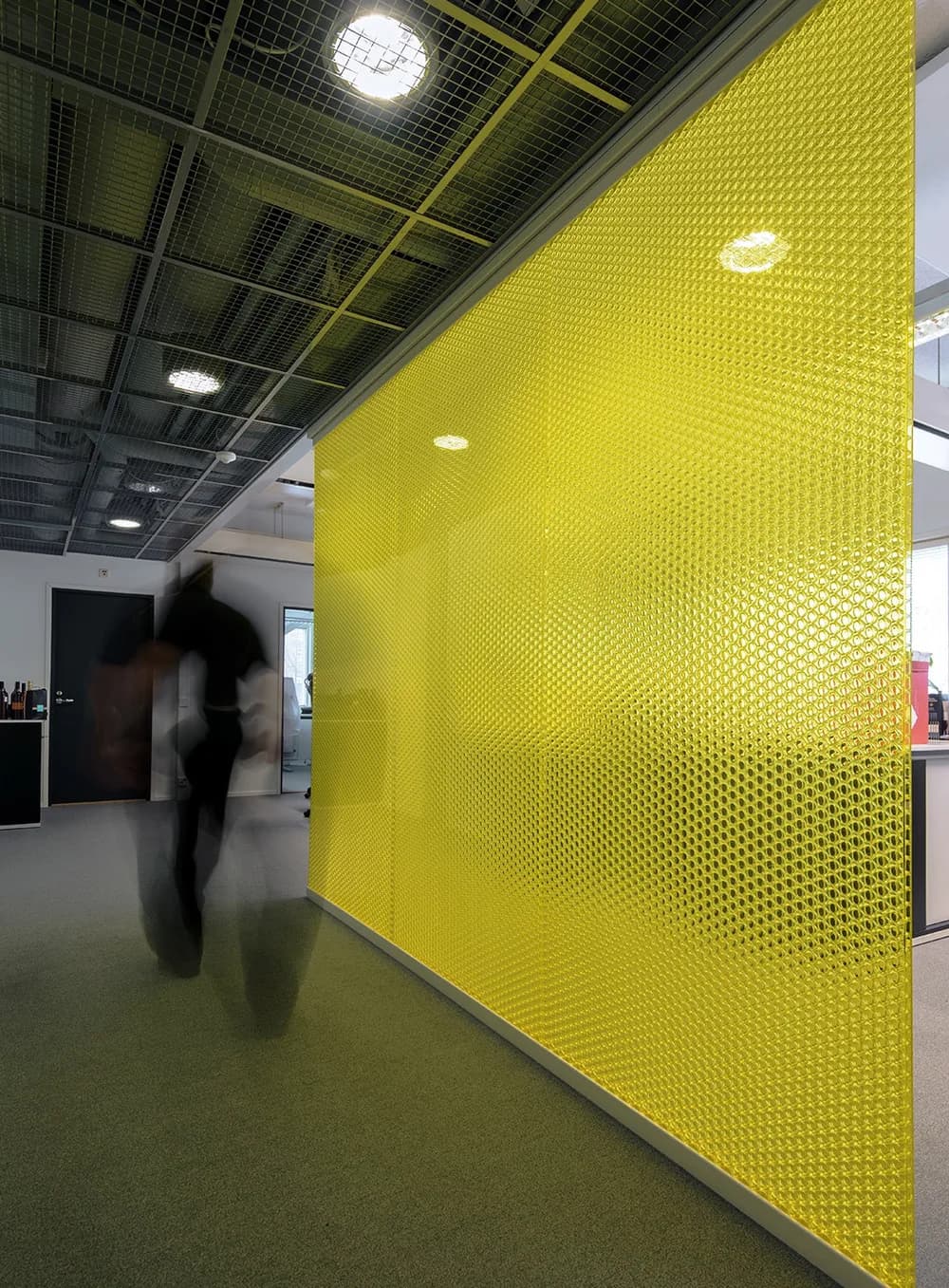 Wallite wall in yellow honeycomb panels with a person walking past