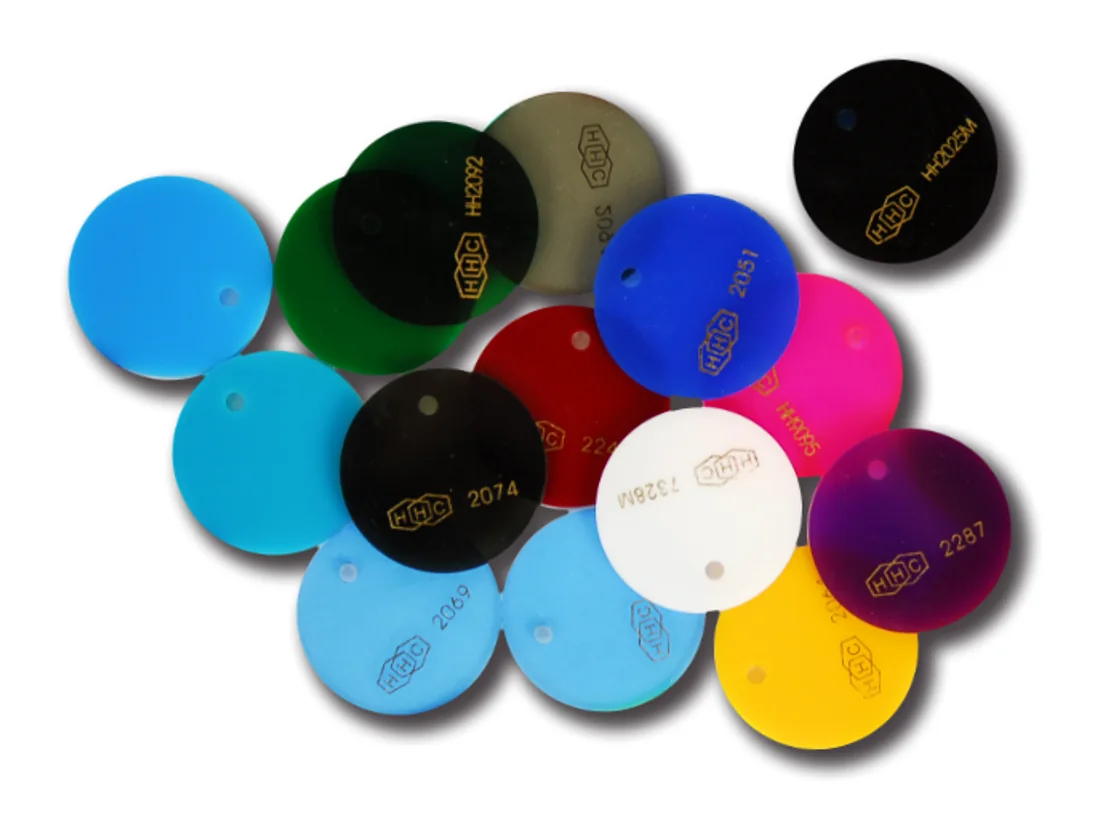 Cast acrylic colour chips in blue, green, red, magenta, yellow, white and black, each stamped with the gold HHC hexagon and its own colour code