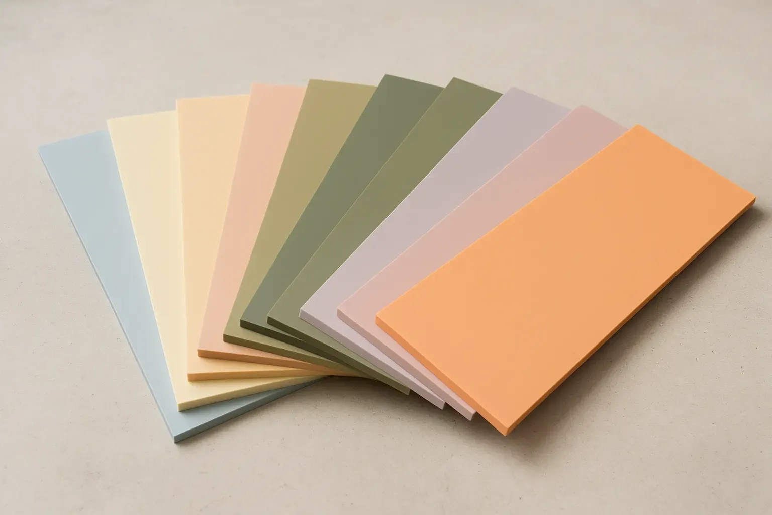 Nine pastel acrylic sheets fanned out, each showing its matte face and cut edge