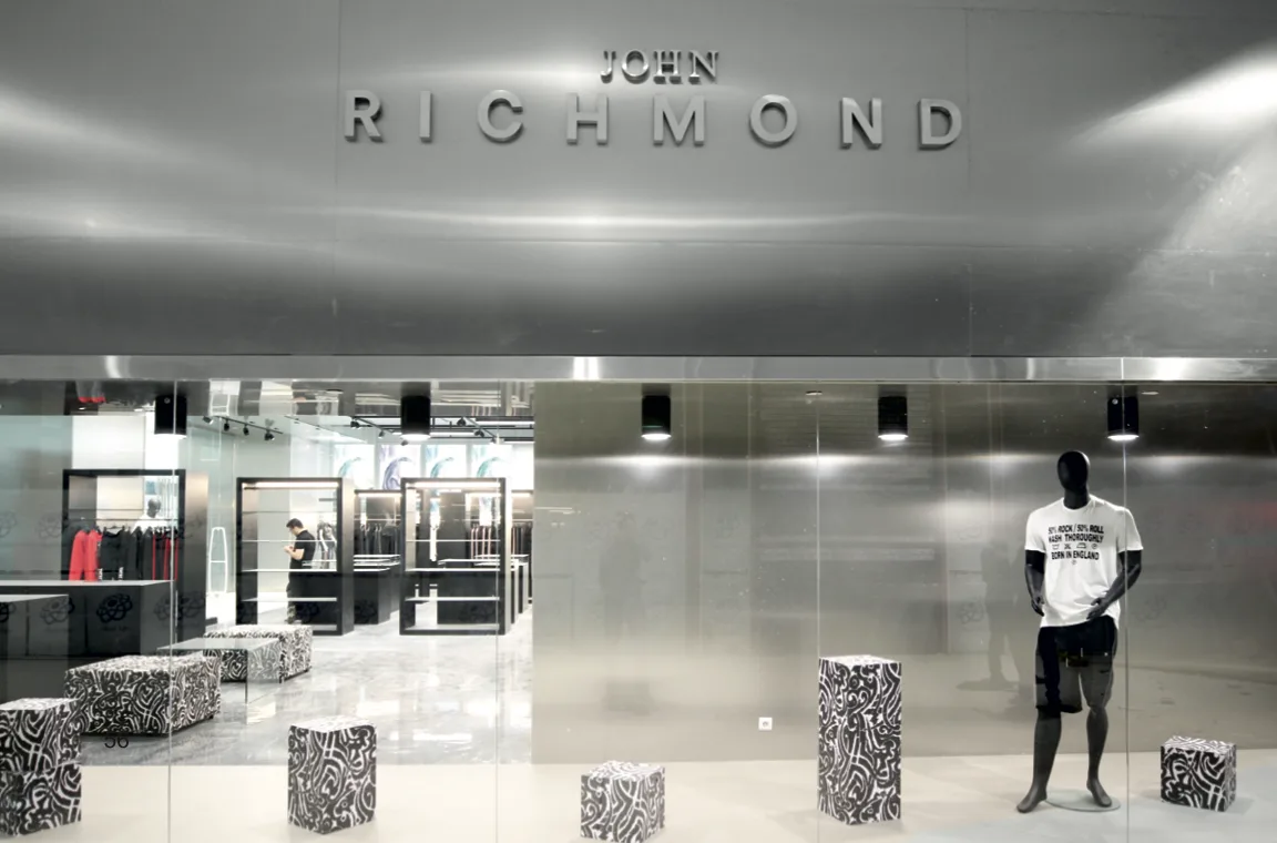 John Richmond luxury retail store with silver ACM panels and metallic finishes